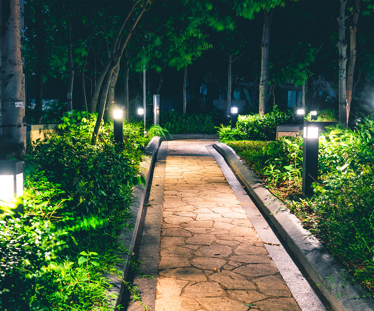 A path in the middle of a park at night.