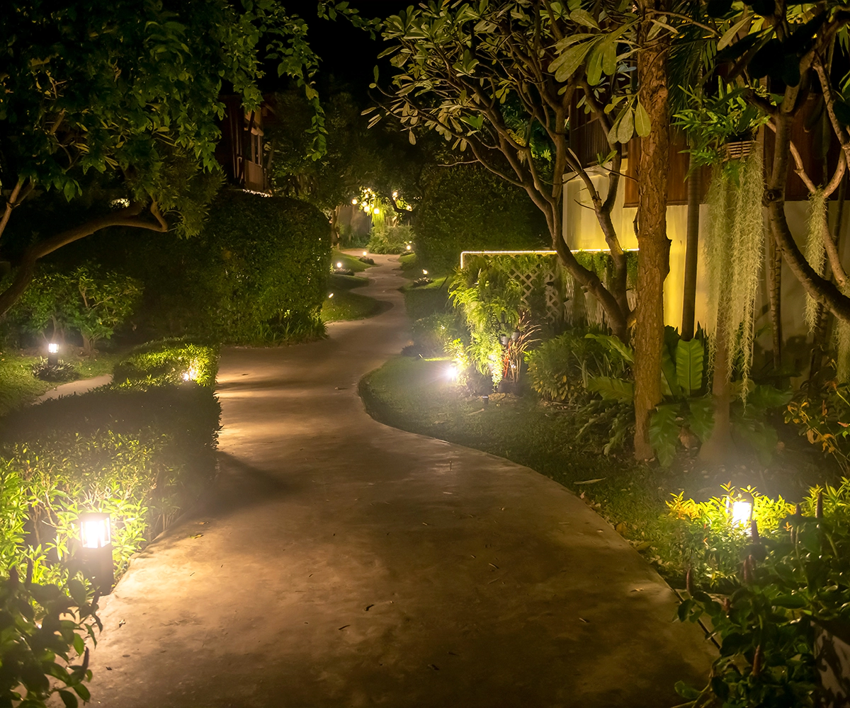 A path with lights on it in the night.