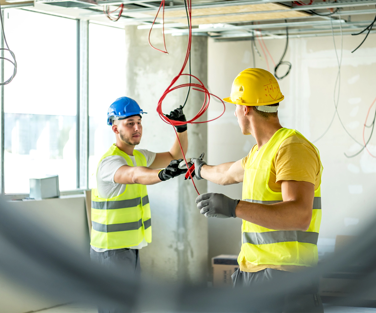 Two construction workers are working together on a project.